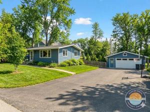 a home with a blue house and a driveway at Pet-Friendly Lake Como Retreat 2BR in Lake Geneva