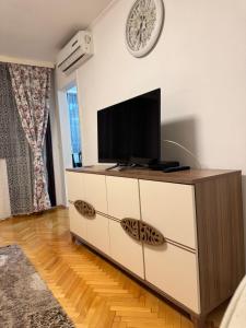 a living room with a flat screen tv on a dresser at Apartman 7 Foča in Foča