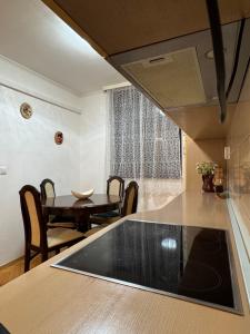 a kitchen and dining room with a table and a dining room at Apartman 7 Foča in Foča