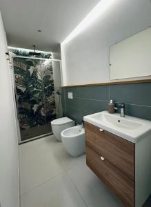 a bathroom with a sink and a toilet and a mirror at Blu Bolivar in Marina di Camerota +6 photos