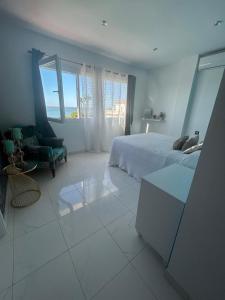 a bedroom with a bed and a chair and a window at Chalet con 3 habitaciones Luz De Doñana in Mazagón +21 photos