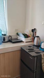 a kitchen with a stove and a counter top at Hanna's Condo at Sanremo Oasis in Cebu City +2 photos