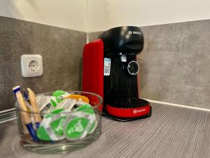 a coffee maker sitting on a counter next to a bowl of chips at Kleine Einraumwohnung am Fleth in Jork