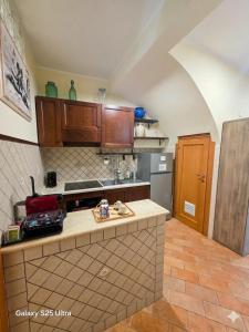 a kitchen with wooden cabinets and a counter top at Dimora Sogno Suite in Termoli