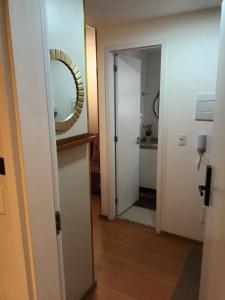 a hallway with a mirror and a white door at Studio Itaú Metrô Conceição in São Paulo +15 photos