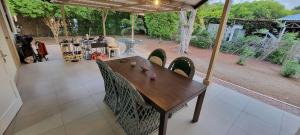 a wooden table and chairs on a patio at Homey Haven in Willemstad