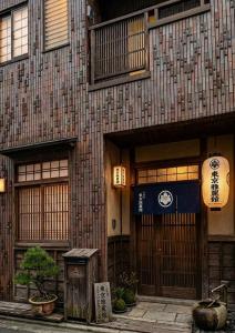 a building with wooden doors and windows on a street at 東京雅麗館 in Tokyo