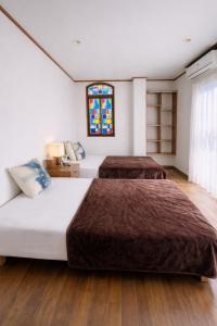 a bedroom with two beds and a stained glass window at 東京雅麗館 in Tokyo +9 photos