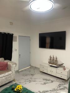 a living room with a couch and a flat screen tv at Villa Rivera in Boca Chica