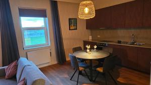 a kitchen and dining room with a table and chairs at B&B T'Rest - Park ter Rijst in Heikruis
