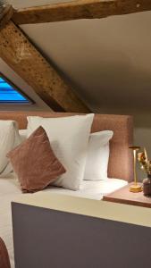 a bedroom with a bed with white pillows at B&B T'Rest - Park ter Rijst in Heikruis +142 photos