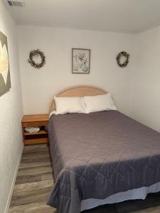 a bedroom with a bed and two wreaths on the wall at Welcome to Highland Shore in Ellenton