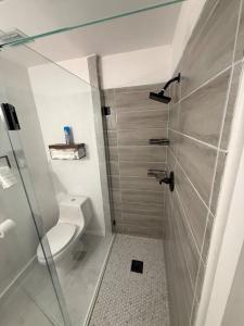 a bathroom with a toilet and a glass shower at Welcome to Highland Shore in Ellenton