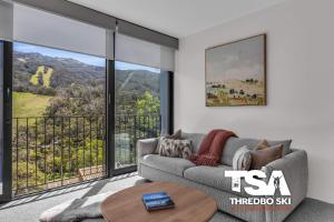 a living room with a couch and a table at Black Bear 402 in Thredbo