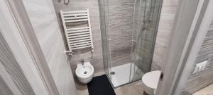a bathroom with a toilet and a sink and a shower at La Locanda del Giardino in Lentate sul Seveso +2 photos