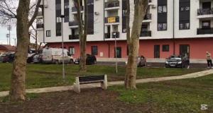 a park with a bench in front of a building at ESEM stan na dan in Modriča +4 photos