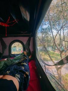 a person sleeping in a tent with a window at 4x4 RoofTent Camper Offroad in Tirana