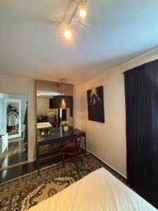 a bedroom with a bed and a desk with a mirror at Raufoss Villa Residence in Raufoss