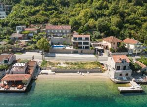 an aerial view of a beach with buildings and water at Seafront Villa with Private Pool & Beach in Kotor Bay, Villa Viborg in Kotor