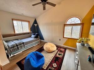 a bedroom with a bed and a ceiling fan at 6BR Luxury Mountain Retreat - Hot Tub, Game Room, Lake, Beach, Karaoke, Bar, Poconos in Albrightsville +68 photos