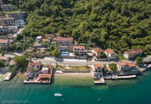 an aerial view of a house on the water at Seafront Villa with Private Pool & Beach in Kotor Bay, Villa Viborg in Kotor