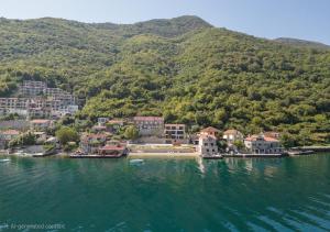 a small town in the middle of a body of water at Seafront Villa with Private Pool & Beach in Kotor Bay, Villa Viborg in Kotor