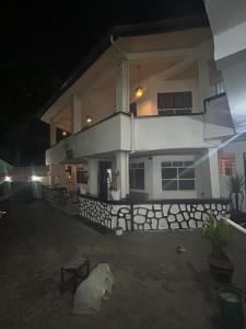 a large white house at night with aphalt at Manch Lodge Vuga Zanzibar in Zanzibar City +9 photos