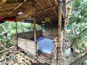 an inside of a tree house with a bed in it at Hijoltola Camping & Resort in Kumāran