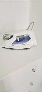 a iron is sitting on top of a drawer at Apê Panoramic Águas Claras e Ministérios in Brasília
