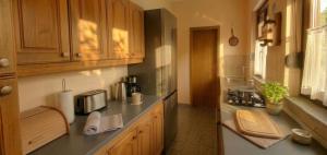 a kitchen with wooden cabinets and a counter top at Apartment Novi II in Kaštela