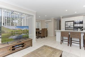 a living room with a large flat screen tv at Aquarius Townhouse in Hawks Nest