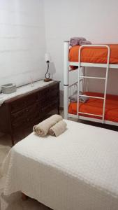 a bedroom with two bunk beds and a desk at El Amuleto in Rivadavia