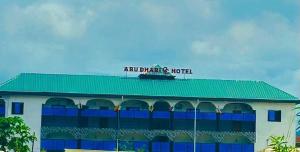 a building with a green roof and a hotel at Abu Dhabi CC Hotel in Limbe