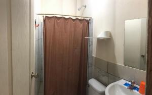 a bathroom with a shower and a toilet and a sink at Habitación orégano in Santa Elena