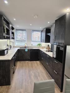 a large kitchen with wooden floors and a counter top at Charming three bedroom house in Durham in Brandon