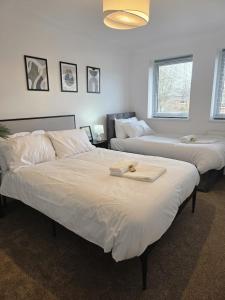 a bedroom with two beds and a room with two at Charming three bedroom house in Durham in Brandon