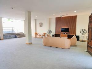 a large living room with couches and a television at Michaels Spring Resort, Natural Hot Spring in Calamba
