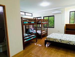 a room with two bunk beds and a bed at Michaels Spring Resort, Natural Hot Spring in Calamba