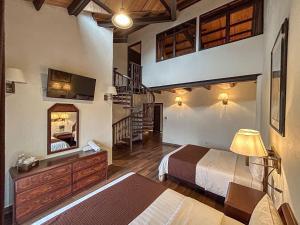 a hotel room with a bed and a staircase at SANTA CECILIA LA MORA HUASCA in Huasca de Ocampo
