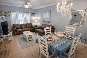 a living room with a dining table and a couch at Swanky 2 Bedroom, Easy Walk to Beach Mar y Sol II # 1 in South Padre Island