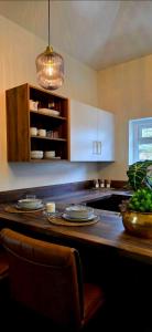a kitchen with a counter with plates on it at Dabbagh Residence in Lees