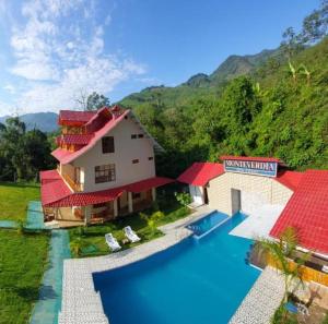 an aerial view of a house with a swimming pool at MONTEVERDIA - Hotel & Resort in Pozuzo