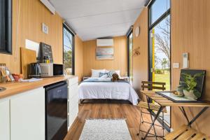 a small kitchen with a bed in a tiny house at Oceans Edge Retreat by Tiny Away in Portland