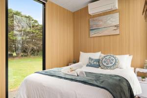 a bedroom with a large bed with a window at Oceans Edge Retreat by Tiny Away in Portland