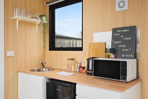 a kitchen with a counter with a microwave and a sink at Oceans Edge Retreat by Tiny Away in Portland