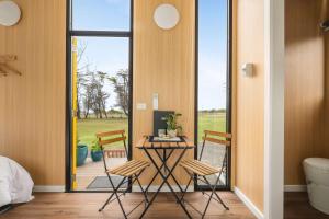 a room with a table and chairs and a bed at Oceans Edge Retreat by Tiny Away in Portland +11 photos