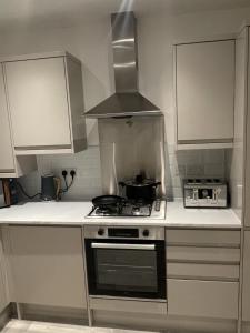 a kitchen with a stove and a microwave at blackburn home in Blackburn