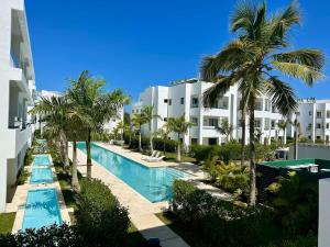 an aerial view of the resort with a swimming pool and palm trees at Punta Cana Retreat in Punta Cana