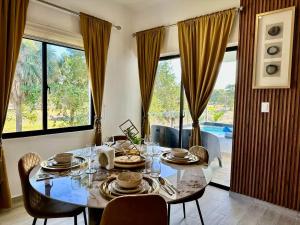 a dining room with a table and a large window at Punta Cana Retreat in Punta Cana
