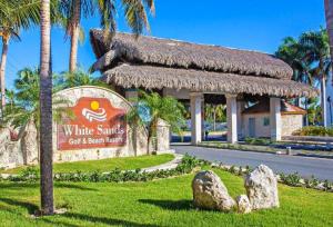 a sign for a white sands golf and beach resort at Punta Cana Retreat in Punta Cana